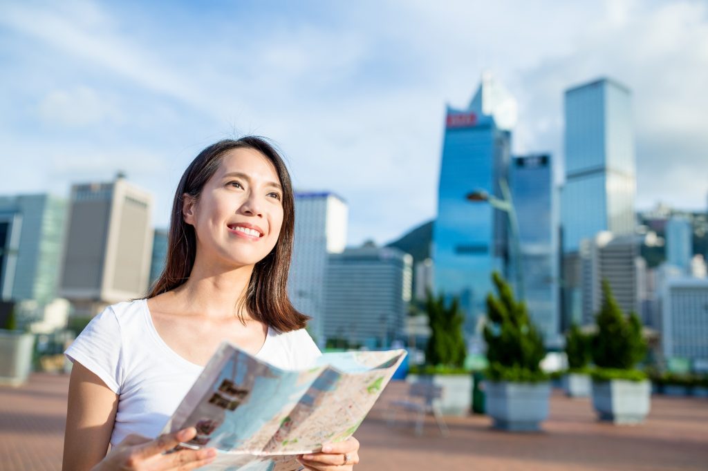Woman using city map in Hong Kong