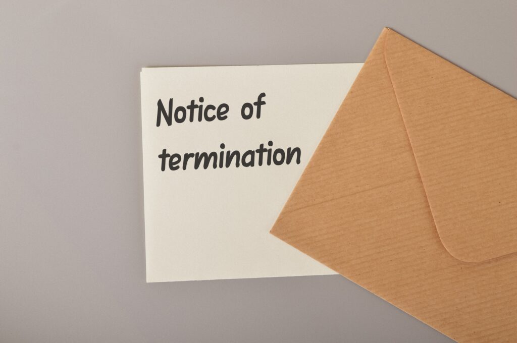 Brown envelope and white paper written with NOTICE OF TERMINATION.