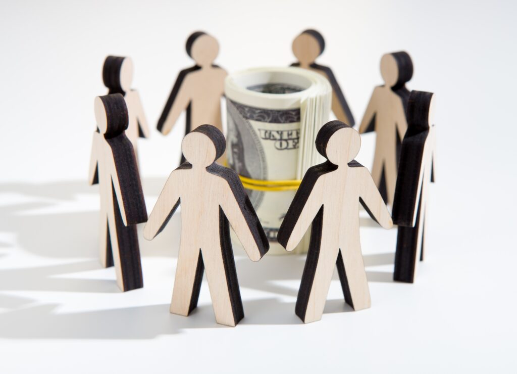 Close up of investors around savings deciding where to invest