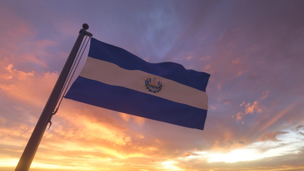 El Salvador Flag on Flagpole by Evening Sunset Sky