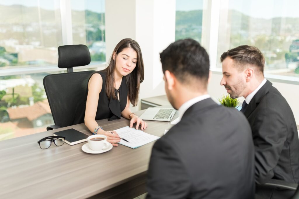 Agents Going Through Rules And Regulations Of Rental Agreement