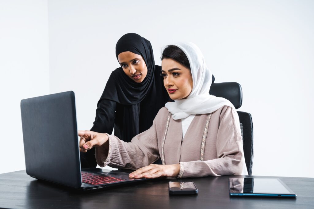 Arabic muslim adult female businesswomen working together in the office in Dubai