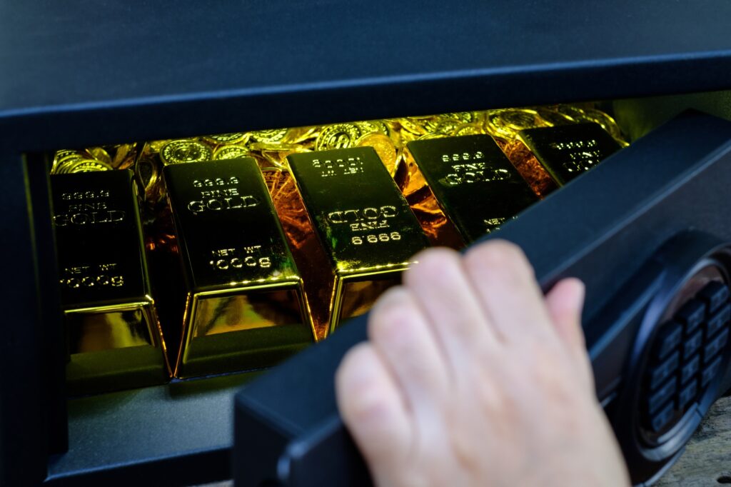 Hand open electronics steel safe box full of coins stack and gold bar
