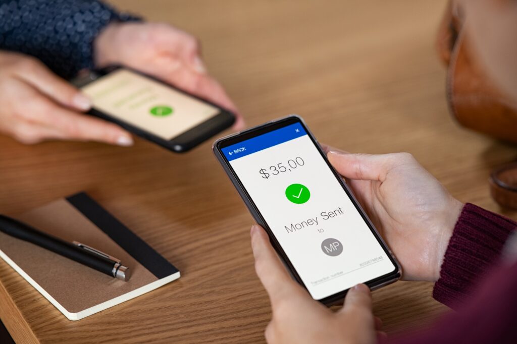Woman sending money with phone